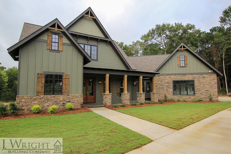 a large house with stone and wood accents