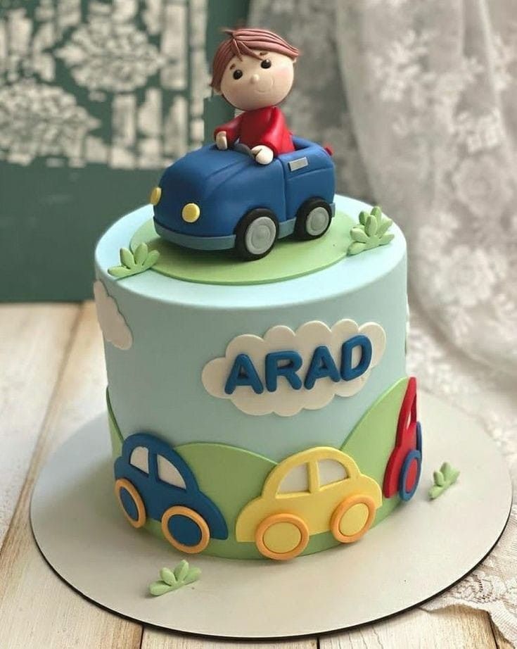 a birthday cake with a little boy on top