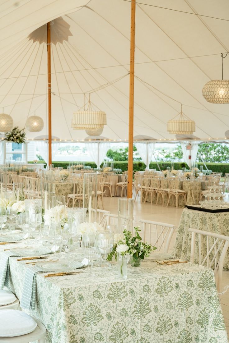 tables and chairs are set up in a tent