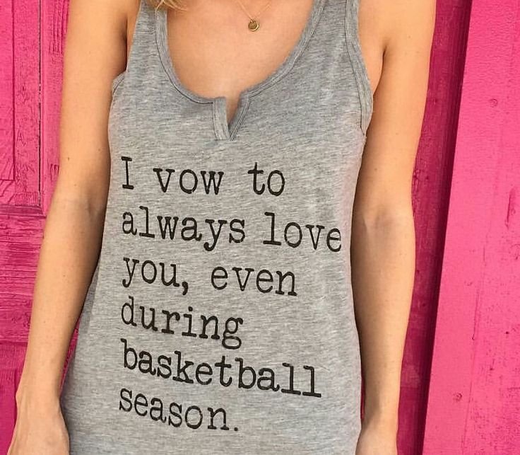 a woman standing in front of a pink door wearing a gray tank top that says i love you, even during basketball season