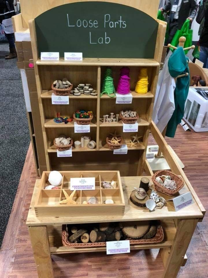 a display case filled with lots of different types of items on wooden shelves in front of a chalkboard