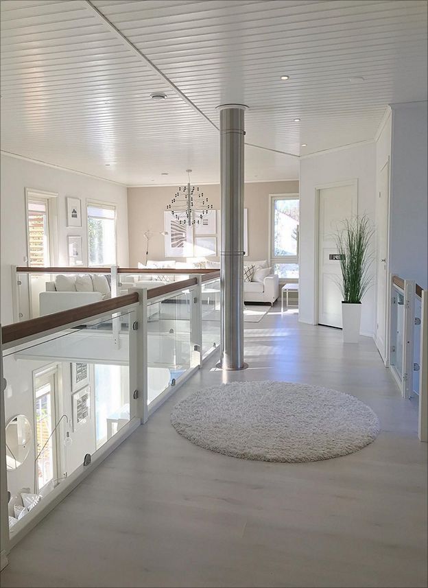 a large white living room with lots of windows