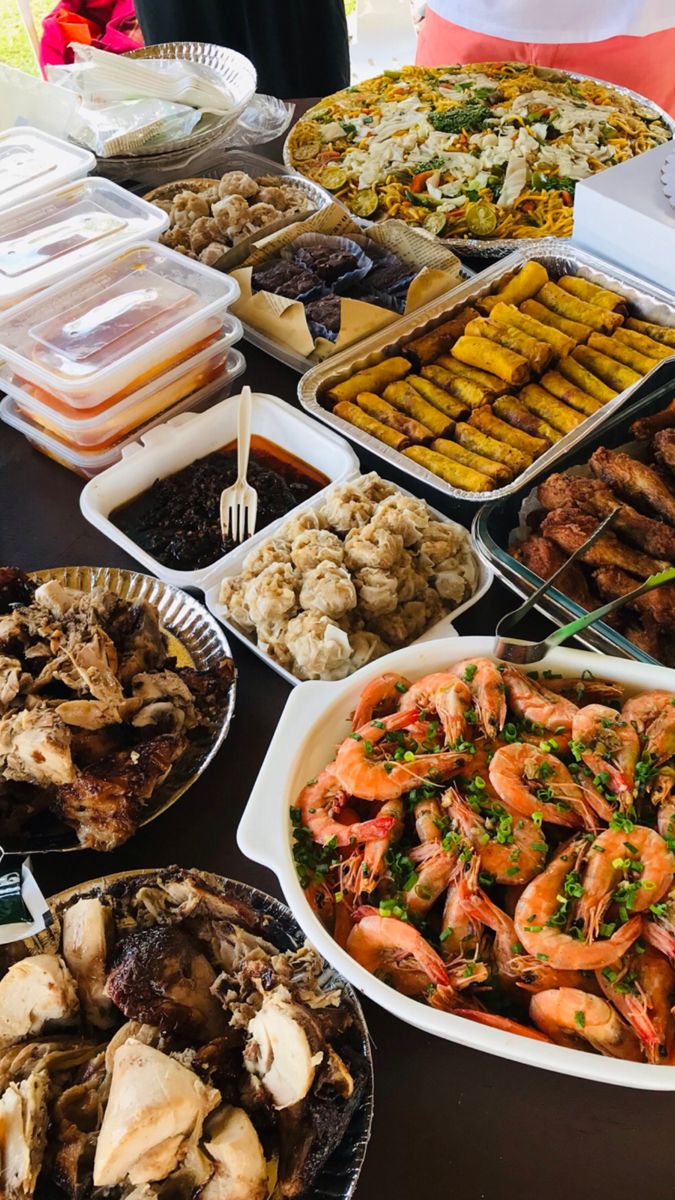 a table topped with lots of different types of food and dishes filled with meats