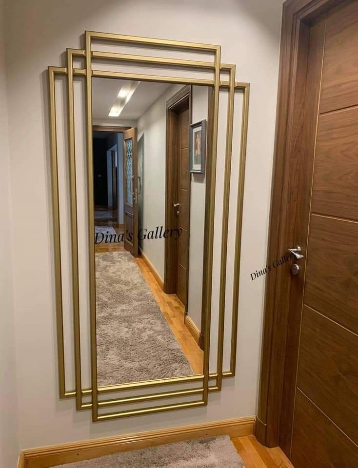 a mirror that is on the side of a wall next to a carpeted floor