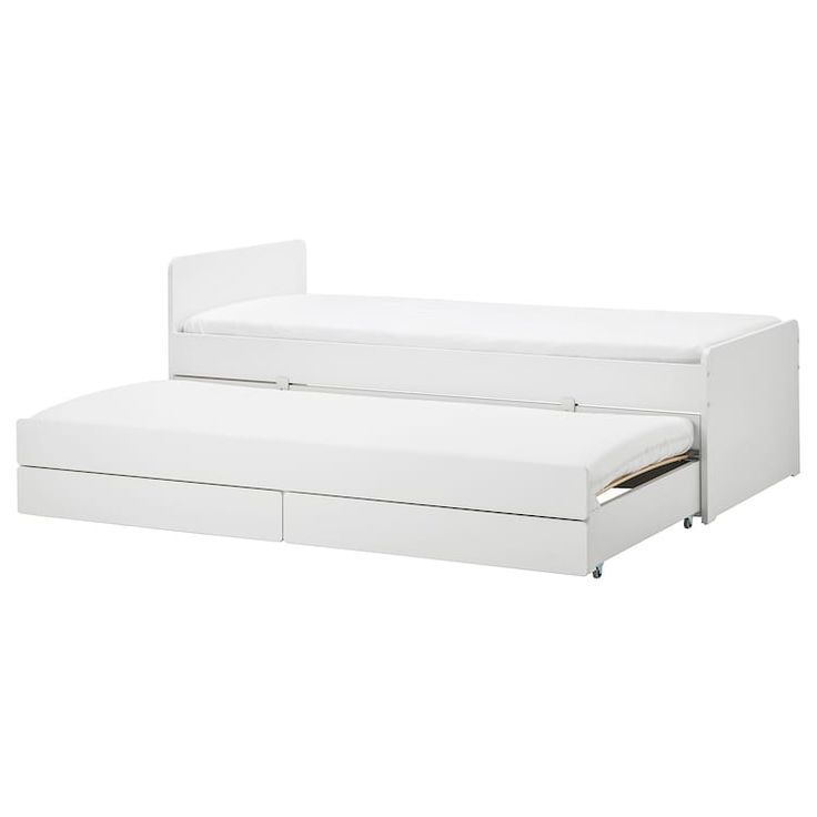 a white bed with two drawers underneath it