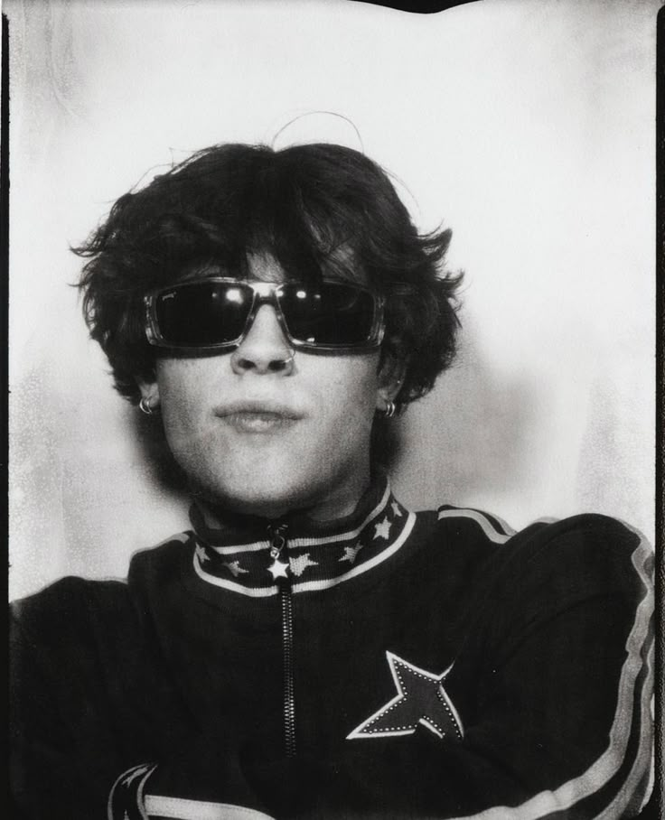 a black and white photo of a person wearing sunglasses