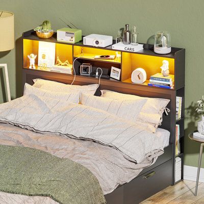 a bed sitting in a bedroom next to a nightstand with a lamp on top of it