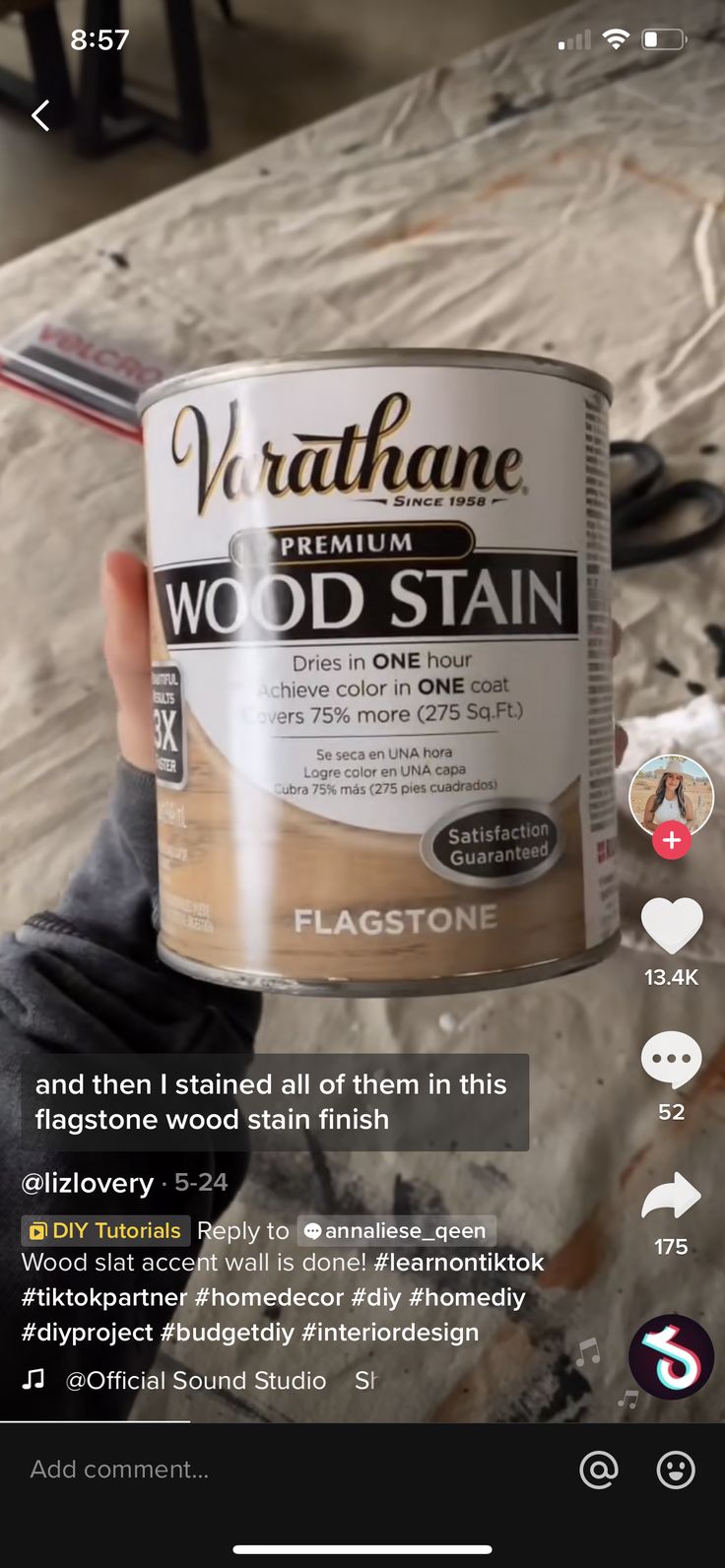 someone is holding up a can of wood stain in their hand and it looks like they are