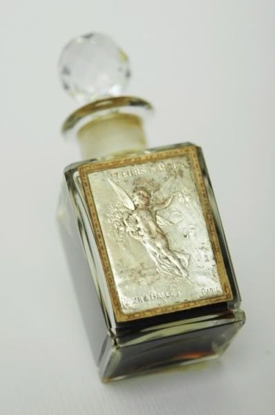 an antique perfume bottle with a glass stopper