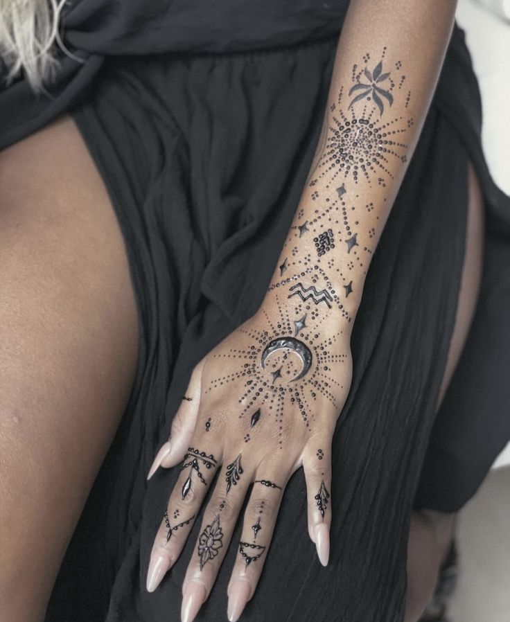 a woman's hand with tattoos on it