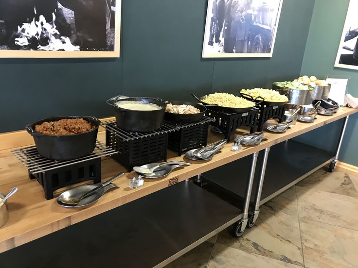 the buffet is ready to be eaten and served at an event or gathering, with pictures on the wall in the background