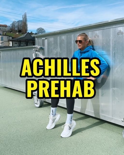 a woman leaning against a wall with the words achilles prehab in front of her