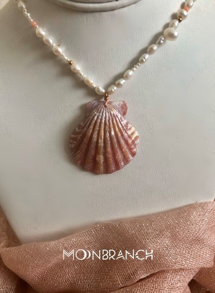 Ocean-inspired Pearl Pendant Jewelry, Elegant Pearl Charm Strand Jewelry, Shell-shaped Pearl Pendant Jewelry, Shell-shaped Jewelry With Pearl Pendant, Shell-shaped Pearl Charm Necklace, Pearl White Mother Of Pearl Shell-shaped Necklace, Pearl Charm Strand Jewelry As Gift, Pearl Charm Strand Jewelry Gift, Mother Of Pearl Shell-shaped Necklace In Pearl White