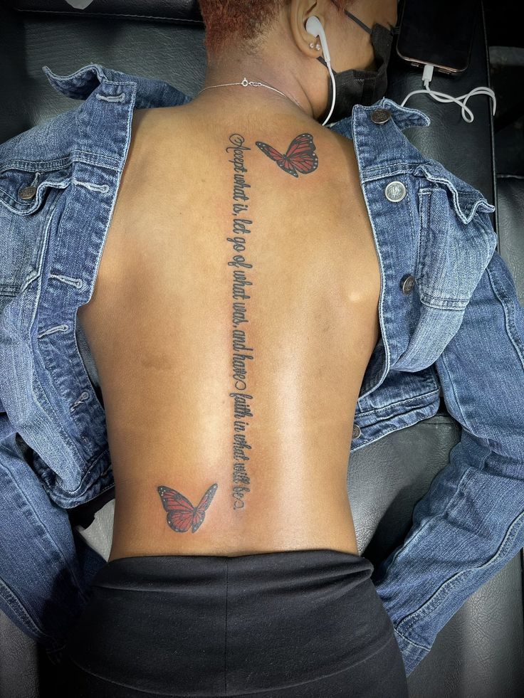 a woman with a butterfly tattoo on her back and the words, love is in the air