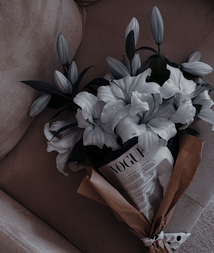 a bouquet of flowers sitting on top of a couch