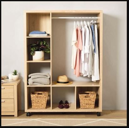 an open closet with clothes and baskets on it