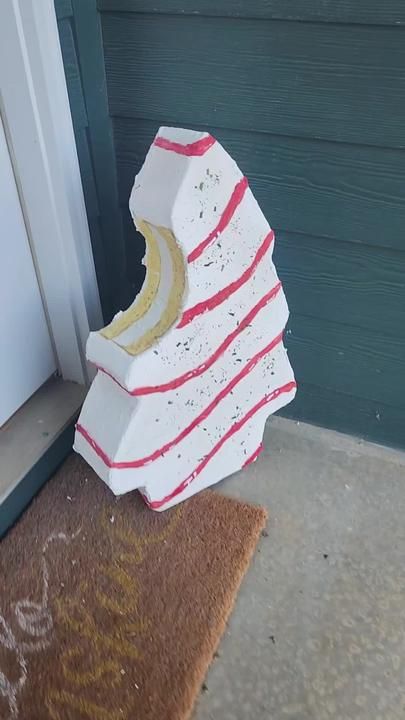 a white and red object sitting in front of a door