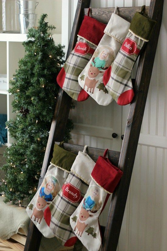 an old ladder is decorated with stockings for christmas