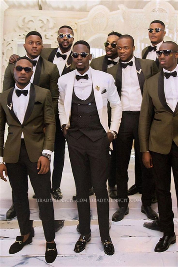 a group of men standing next to each other wearing suits and bow ties with sunglasses on