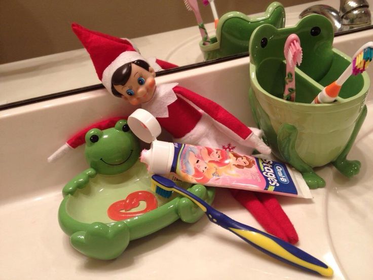 an elf with toothbrushes and toothpaste on the sink