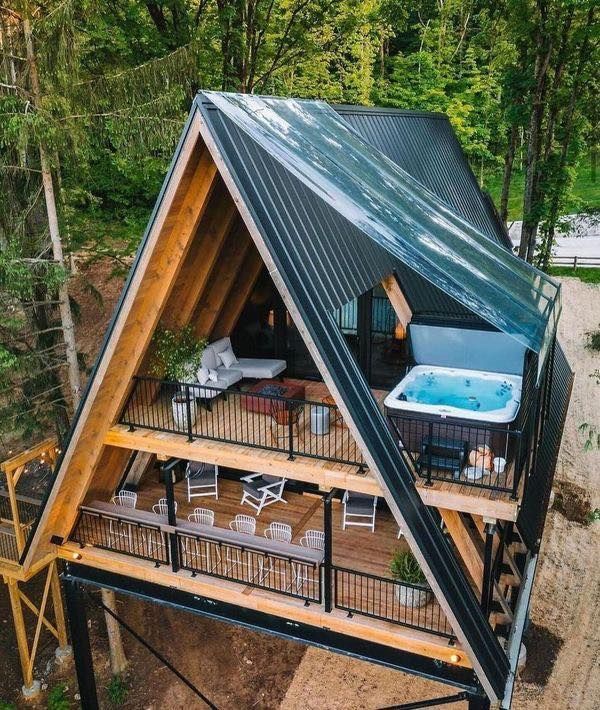 a house with a hot tub in the middle of it's roof and deck