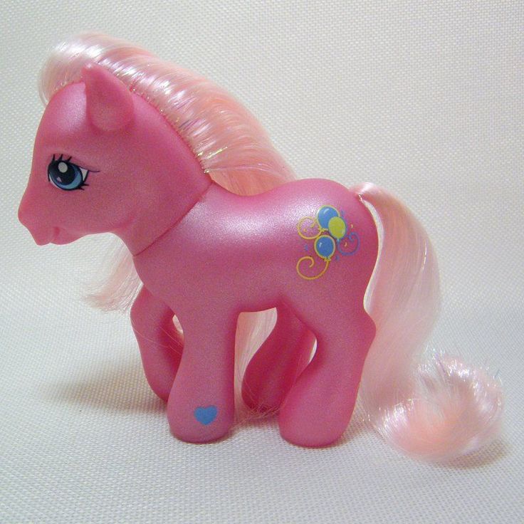 a pink pony toy sitting on top of a white table