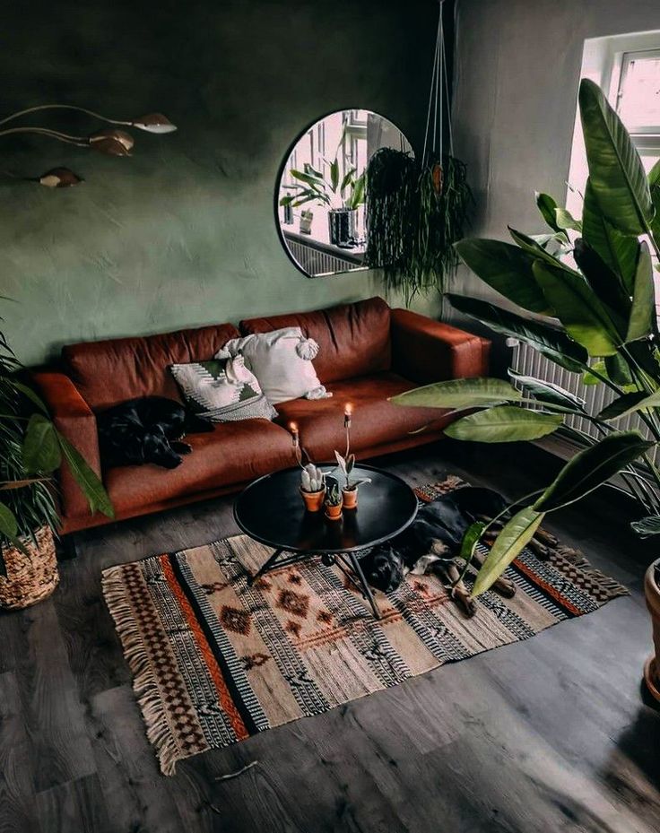 a living room filled with furniture and plants