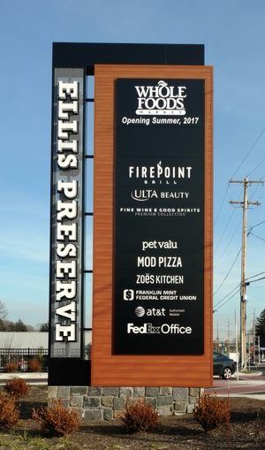 a large sign for a restaurant in front of a parking lot