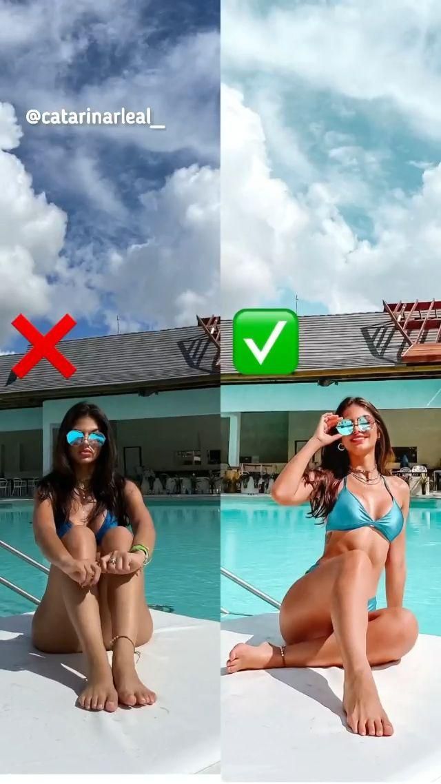 two women in bikinis sitting on the edge of a swimming pool and taking pictures with their cell phones