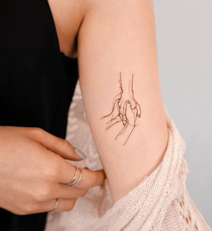 a woman with a small tattoo on her arm