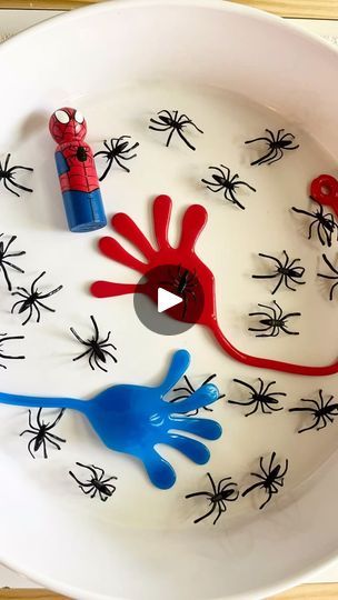 a white bowl with spiderman handprinted on the side and blue hands in the middle