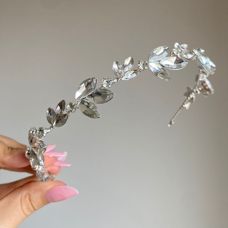 Elevate your bridal ensemble with the ethereal charm of the Silver Frost Leaf Bridal Headband. This captivating piece captures the delicate essence of winter's beauty, adorned with intricate leaves in a shimmering silver hue. Painstakingly crafted with meticulous attention, each leaf mirrors the grace and delicacy of real foliage, adding a touch of enchantment to your special day. The Silver Frost Leaf Bridal Headband serves as a symbol of purity and elegance, a perfect complement to the radiant Silver Hair Accessories, Classic Updo, Tiara Headband, Wedding Hair Inspiration, Headband Tiara, Winter Beauty, Wedding Headband, Bridal Headband, Fancy Jewelry