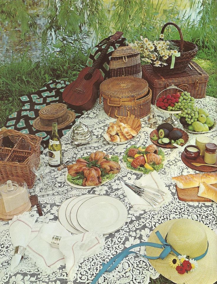 a picnic table with food and wine on it