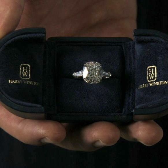 a person holding an engagement ring in a velvet case with the words harry potter engraved on it