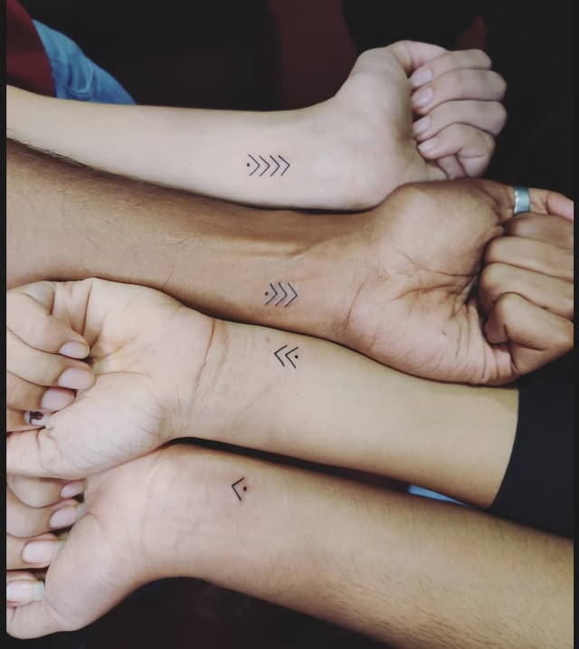 three people with matching tattoos on their arms