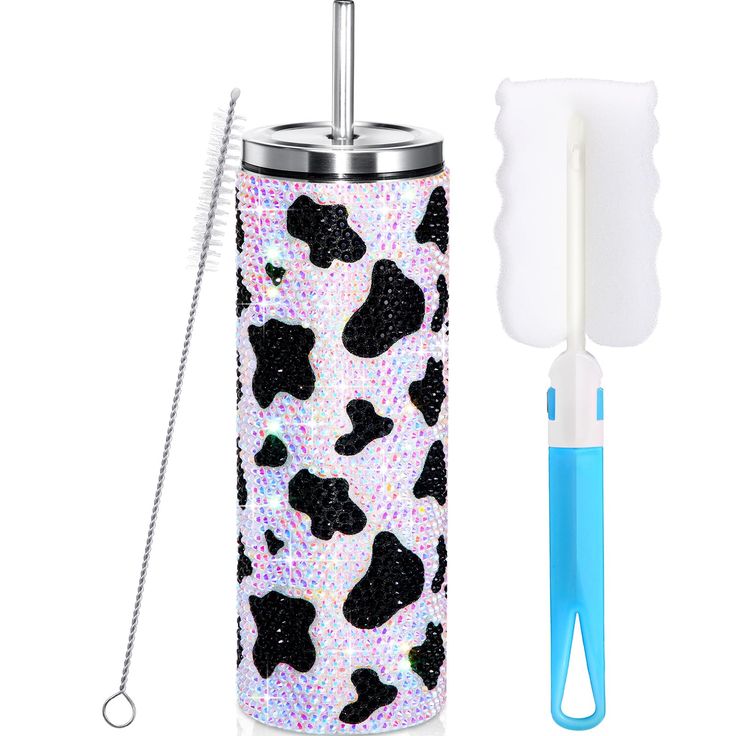 the toothbrush holder is decorated with black and white leopard print, along with a straw