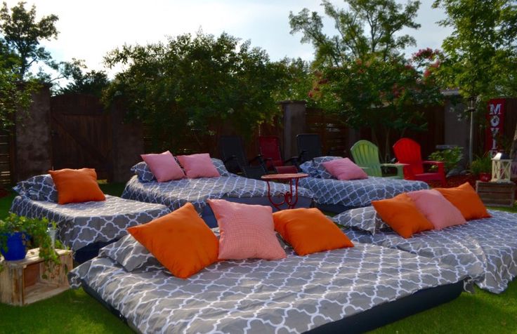 a couple of beds sitting on top of a lush green field