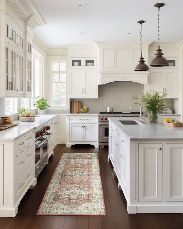 a large kitchen with white cabinets and wood flooring, along with an area rug