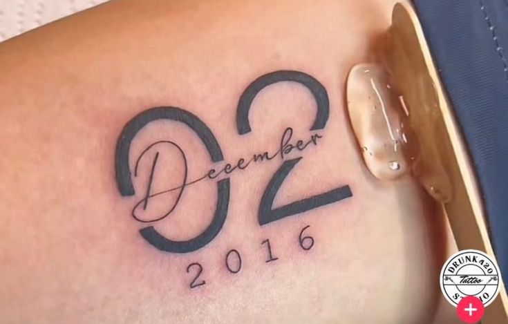 a woman with a tattoo on her thigh that says december 2012 and the date is written in black ink