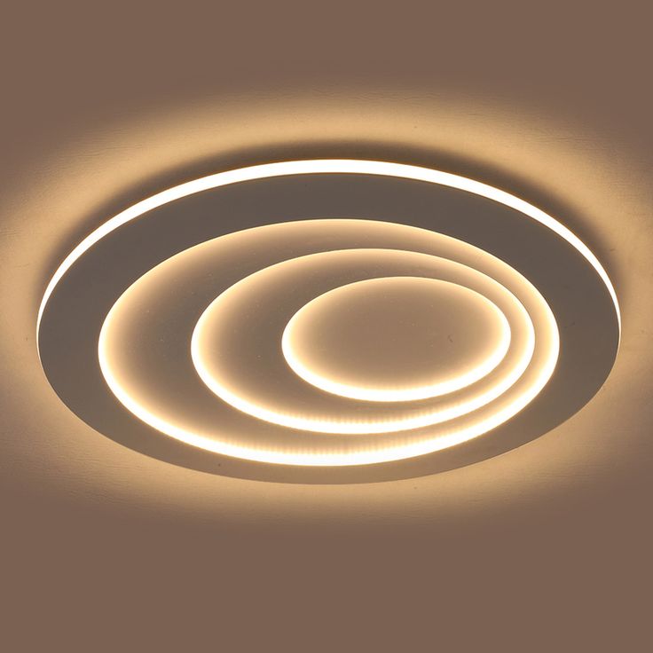 a circular light fixture with dim lighting on the ceiling