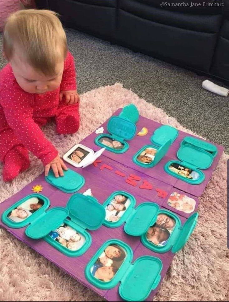 a toddler playing with an assortment of food in her play tray on the floor