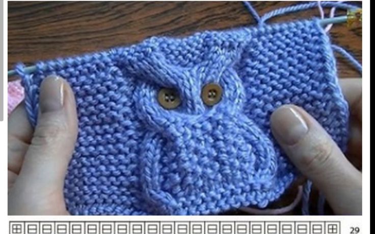 someone is holding up a crocheted blue bag with an owl face on it