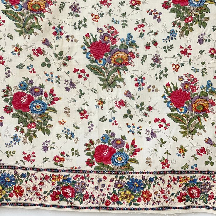 an old rug with flowers and leaves on white background, including red, blue, green, yellow, pink