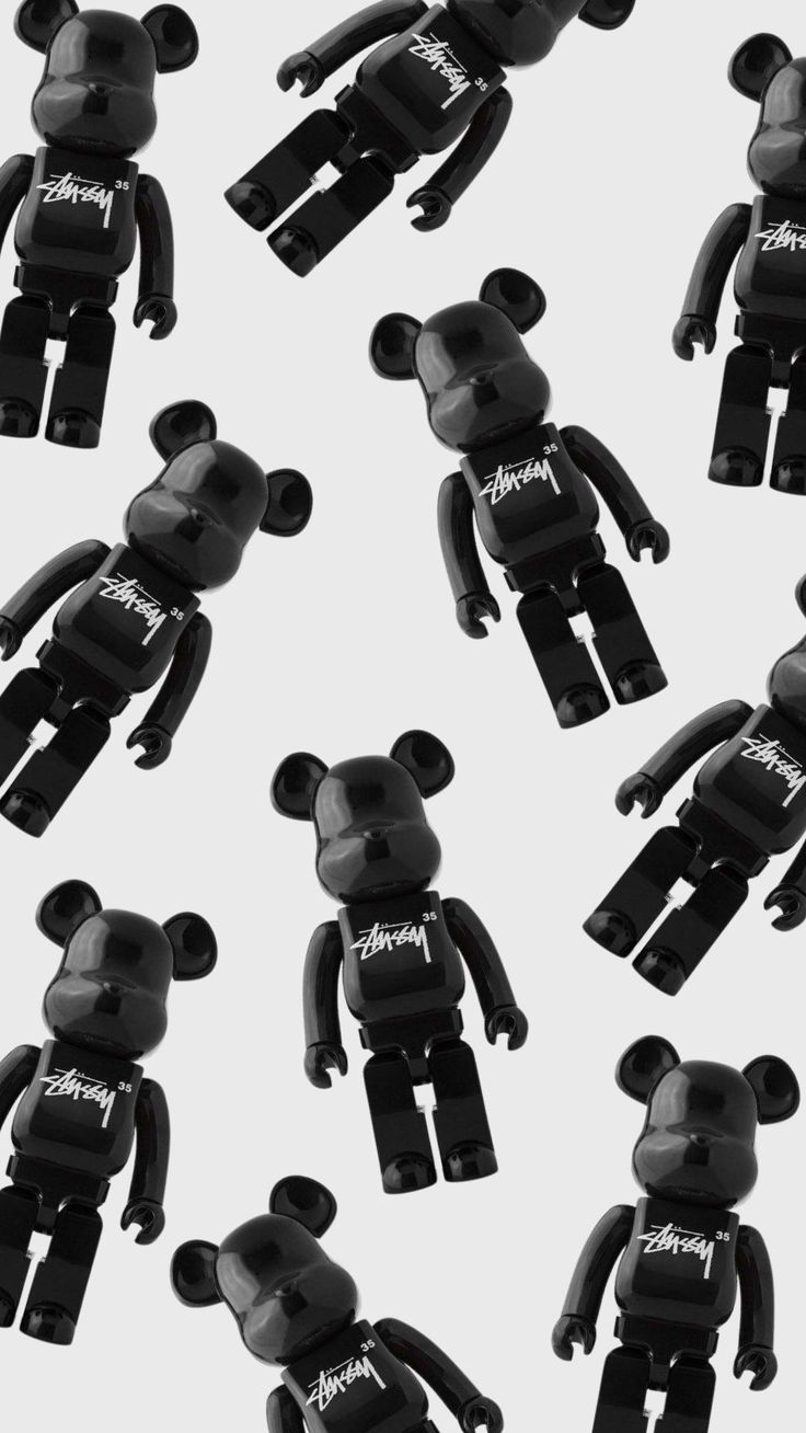 black and white photograph of many different sized toy bears in the shape of mickey mouses