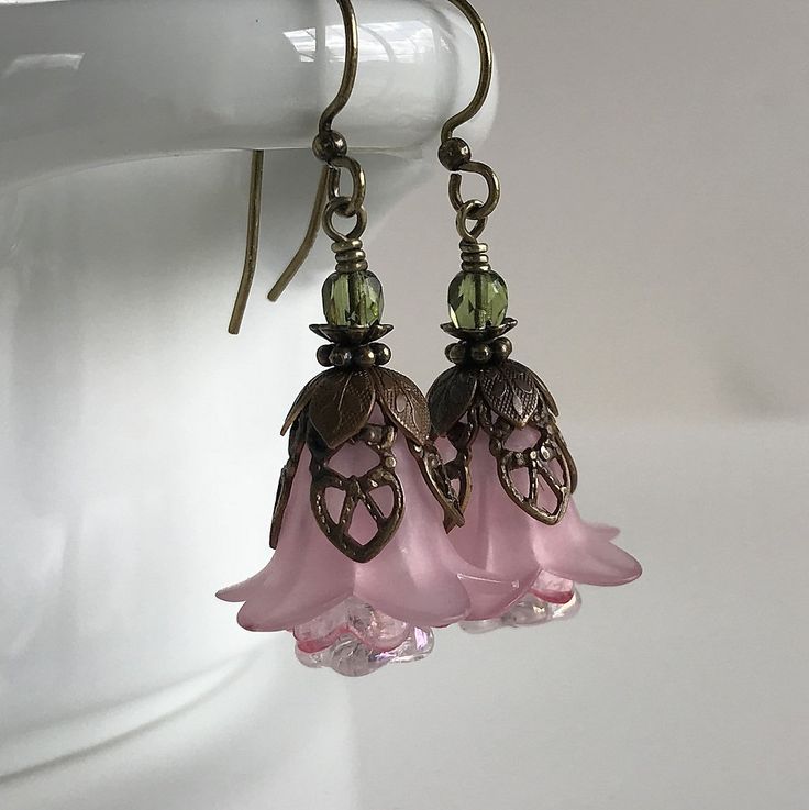 "Pretty in Pink... Add some spring to your wardrobe with these lovely double pink blossoms. Delicate pink petals surround bright pink and white centers. Antique brass filigree caps adorn the tops and a tiny green bead adds a bit of spring pop. These earrings are very lightweight and comfortable to wear. Perfect for a garden wedding, or a gift for a nature lover. And don't forget...Mother's Day is just around the corner. Drop length from bottom of antique brass french earwire: 1\" (25mm) Prefer a Feminine Pink Jewelry With Handmade Flowers, Pink Handmade Flower Earrings For Spring, Pink Earrings With Handmade Flowers For Spring, Spring Pink Earrings With Handmade Flowers, Pink Petal-shaped Earrings For Spring, Pink Feminine Dangle Flower Earrings, Pink Feminine Flower Dangle Earrings, Delicate Pink Flower Earrings For Spring, Feminine Pink Dangle Flower Earrings