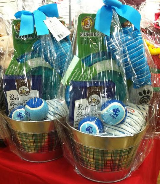 two baskets filled with blue and green items on top of a red cloth covered table