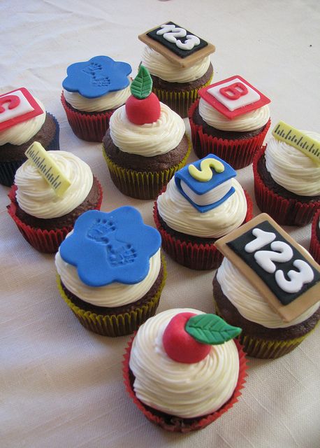 cupcakes with numbers and designs on them sitting on a table