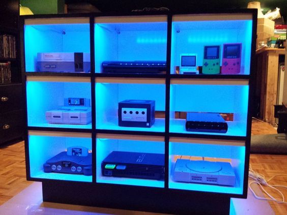 a display case filled with electronic equipment on top of a hard wood floored floor