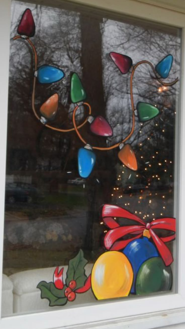 a decorated window with christmas decorations and lights