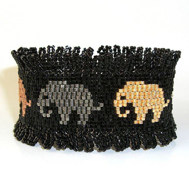 an elephant and zebra beaded bracelet on a white background